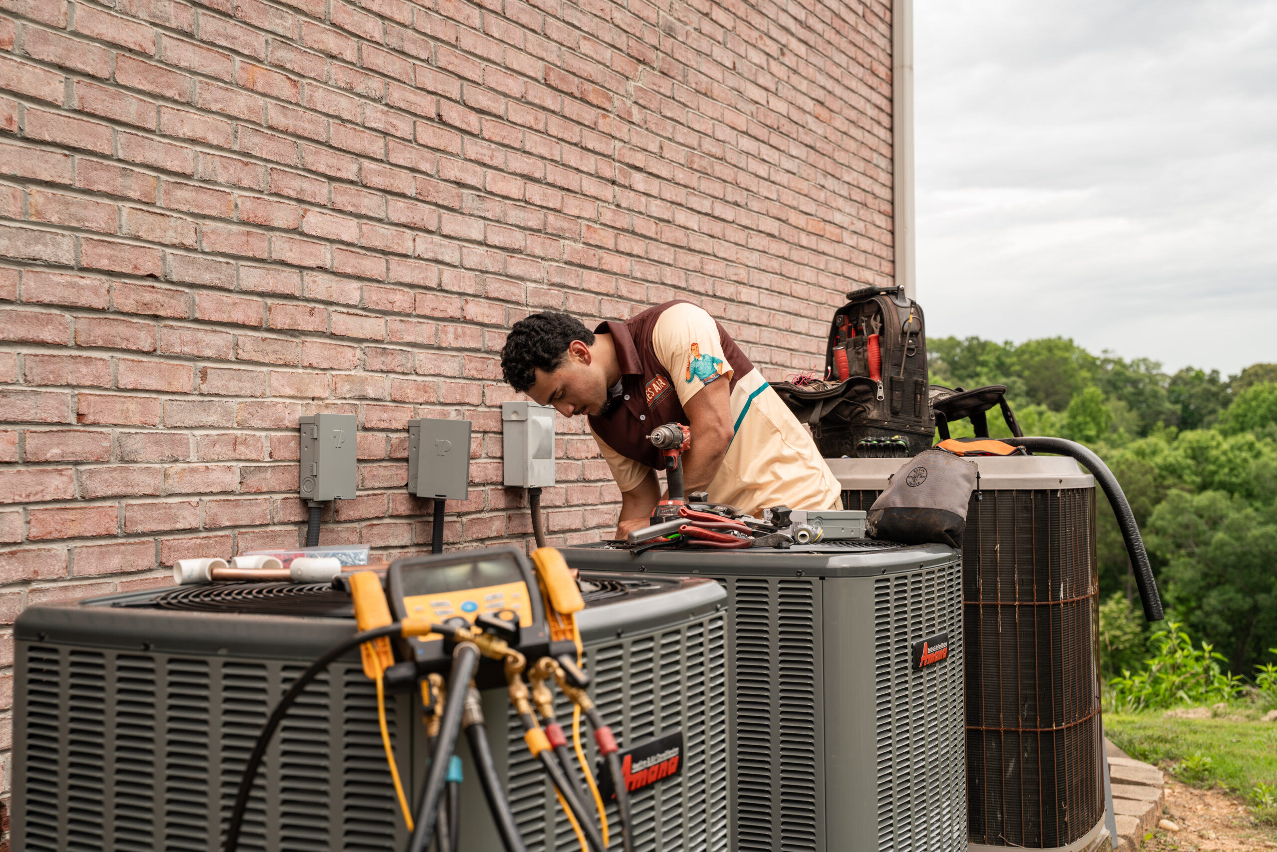 Technician completing a new air conditioning installation in a residential property